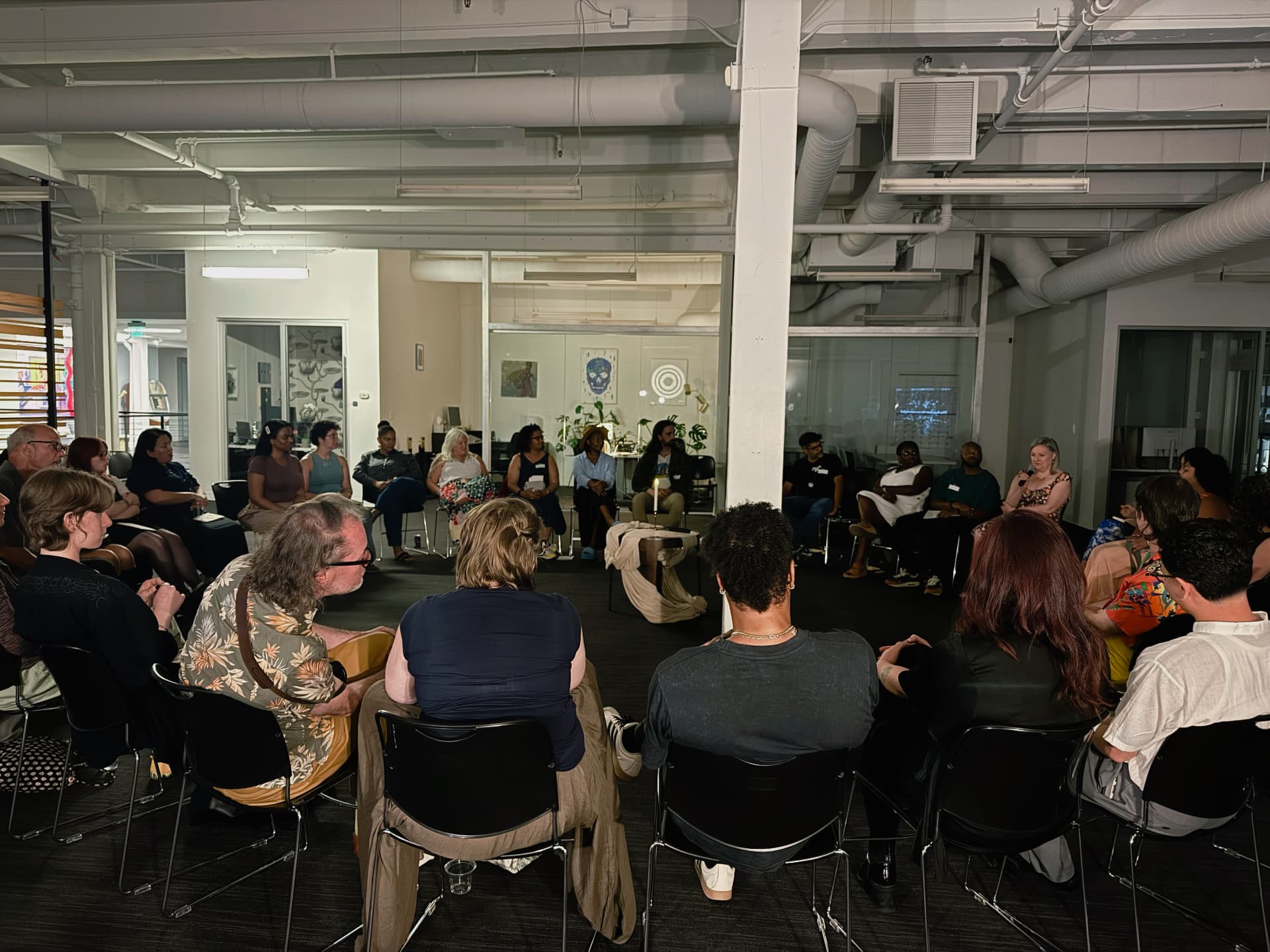 The full circle of chairs filled with guests at Gathering No. 1